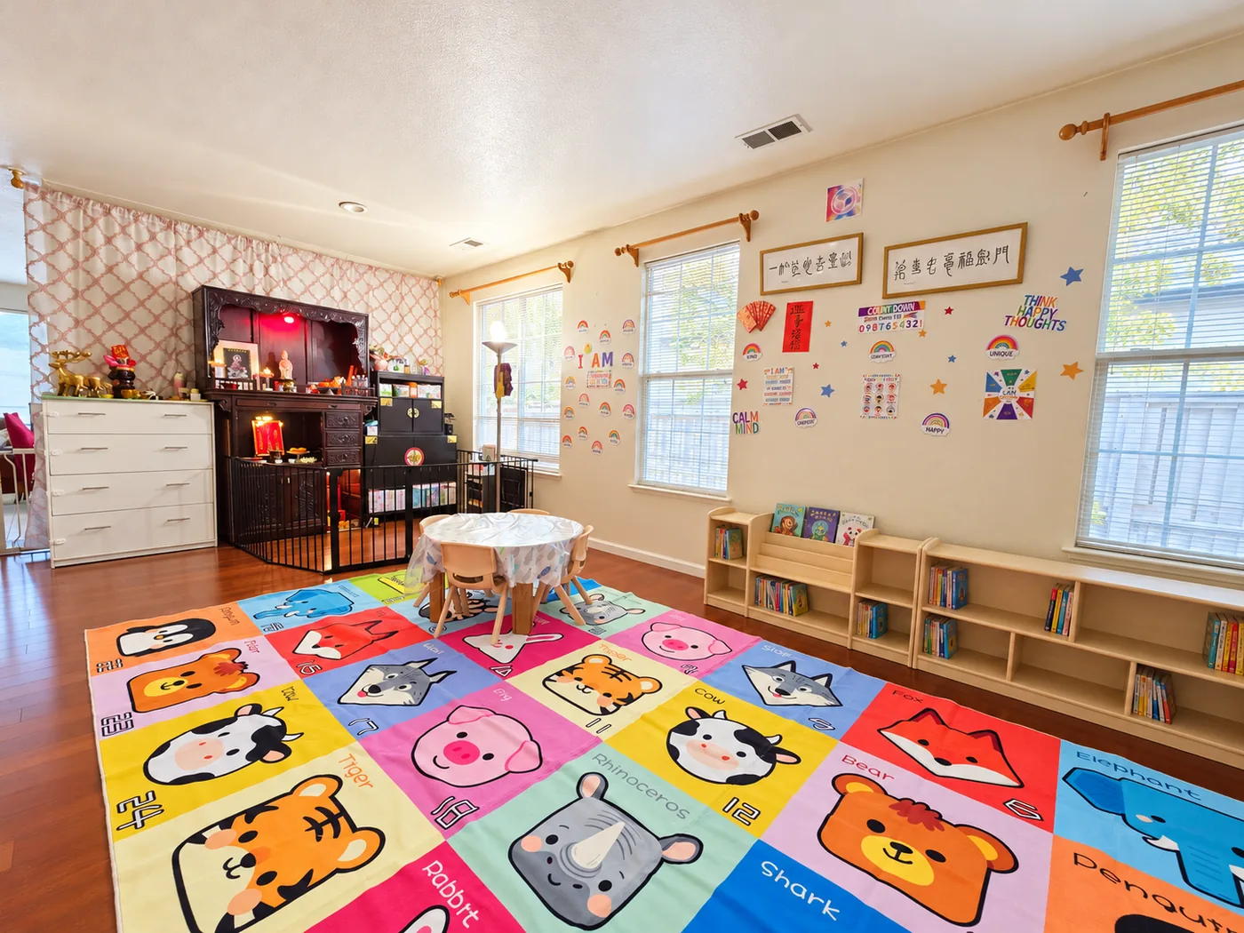 Playroom corner at Lia's Preschool showing Chinese calligraphy artwork and red Lunar New Year decorations alongside English affirmation cards